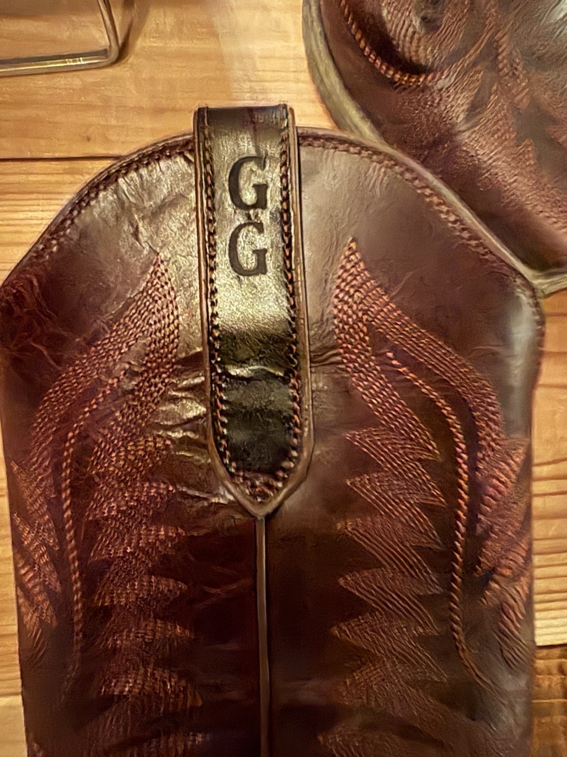 Close-up of GG initials branded onto a leather cowboy boot