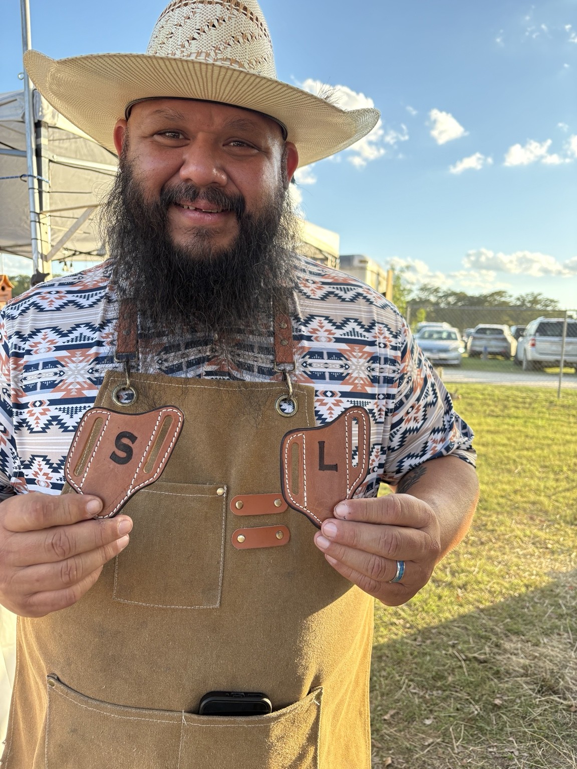 Smiling guest holding personalized leather items