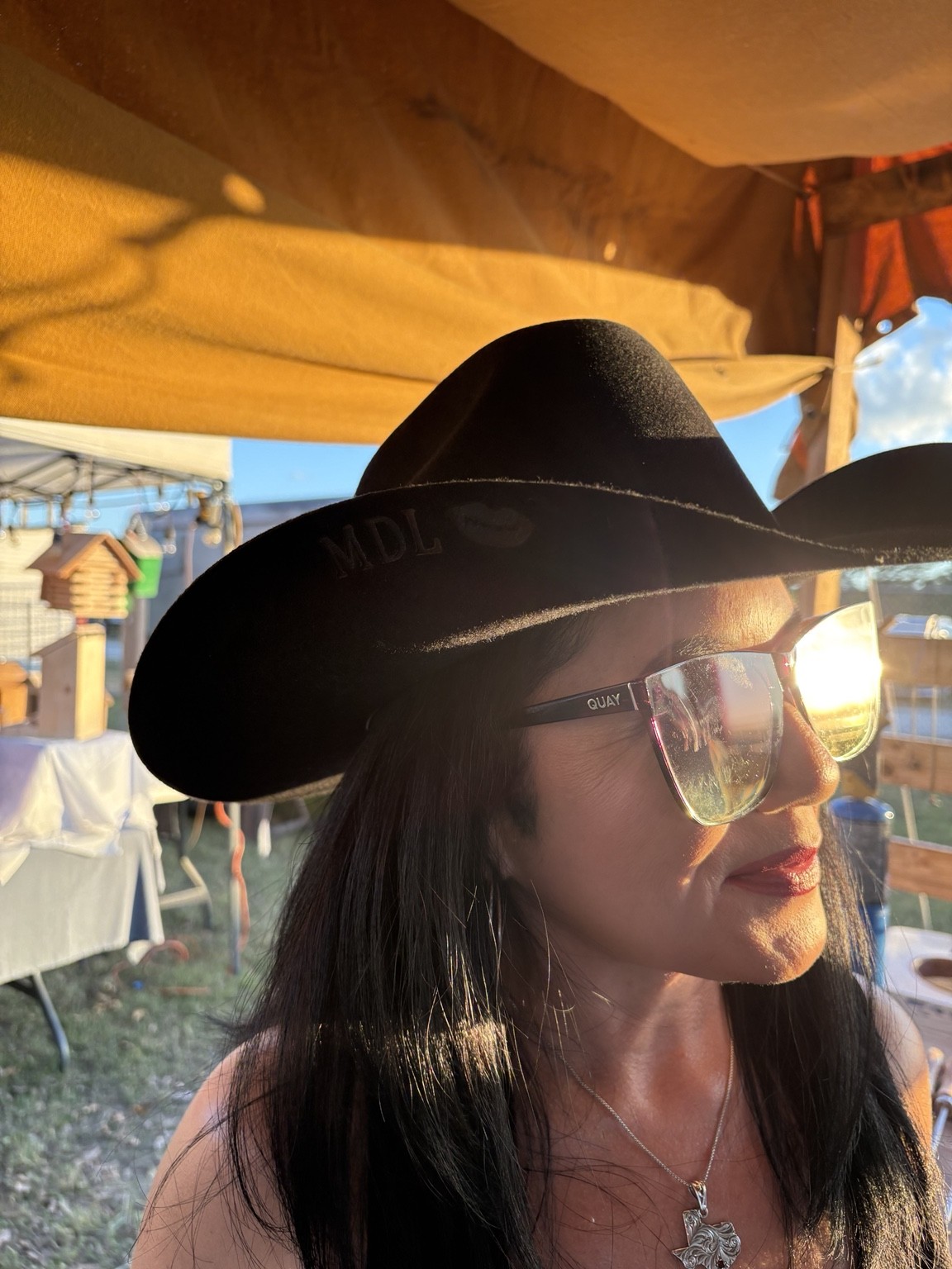 A guest wearing a finished black cowboy hat