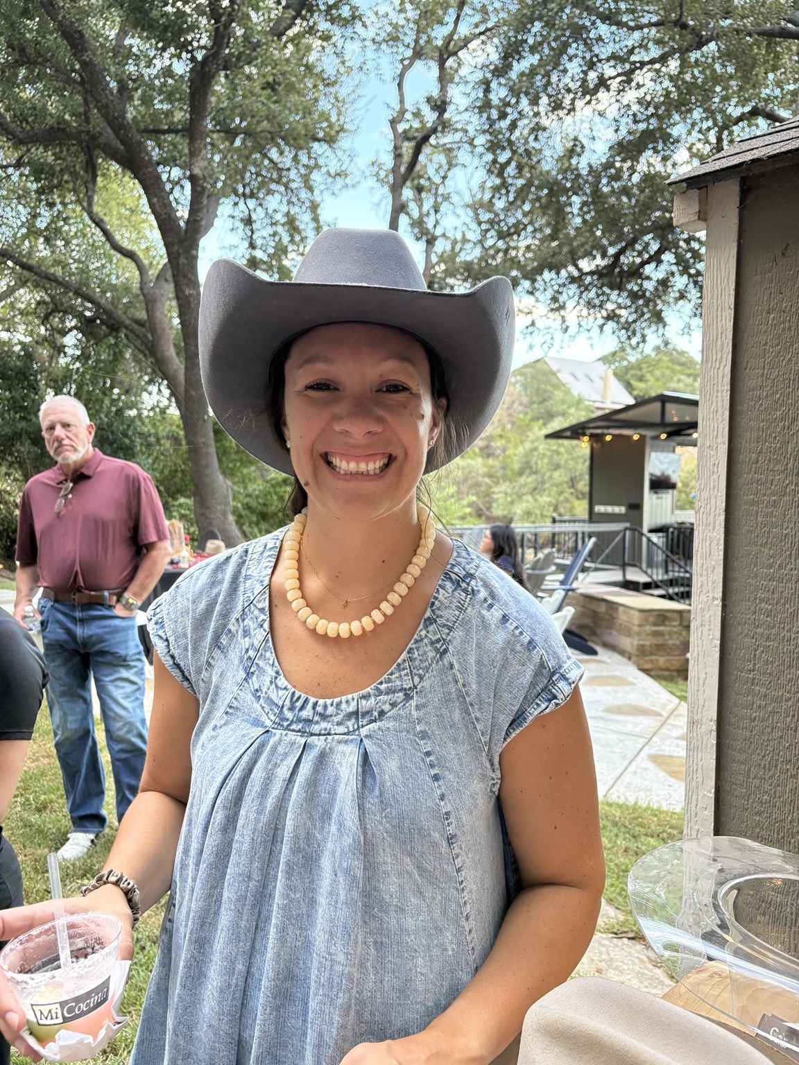 Smiling event guest wearing her finished cowboy hat