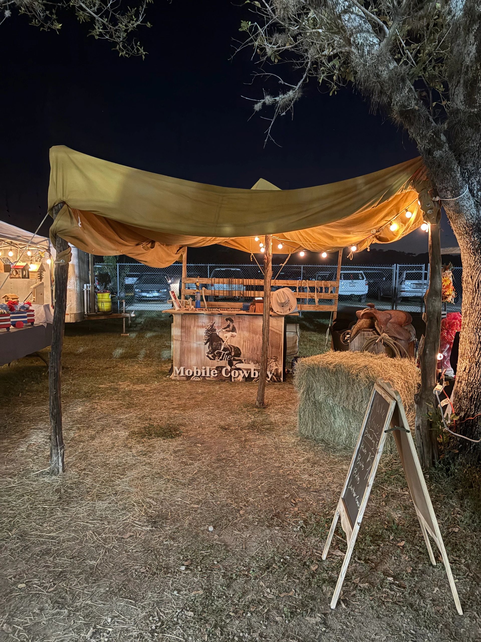 The Mobile Cowboy outdoor hat bar at an evening event