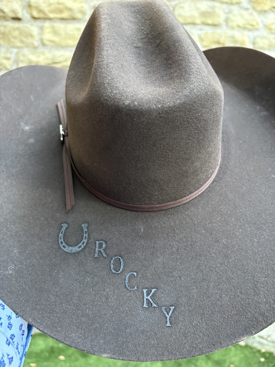 Gray felt cowboy hat with a horseshoe and ROCKY branding on the brim