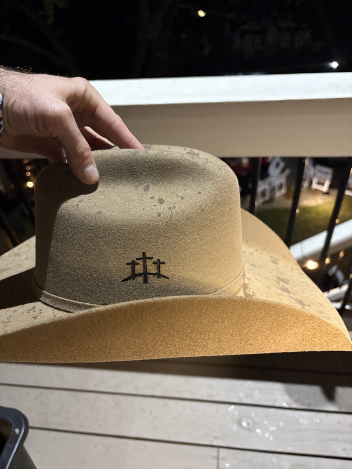 Tan felt cowboy hat personalized with a three-cross brand